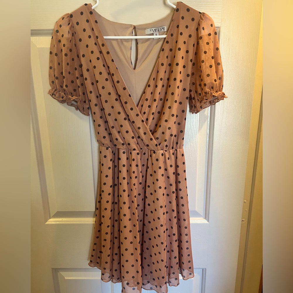 Mauve dress with black polka dots.